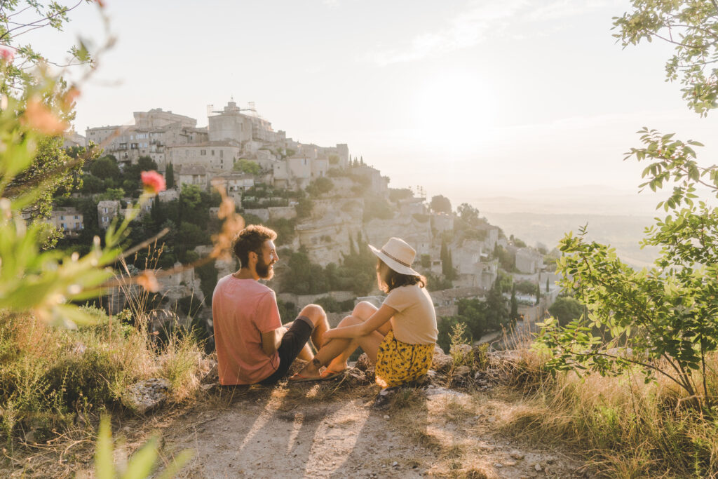 Woman and man looking at scenic view of Gordes village in Provence